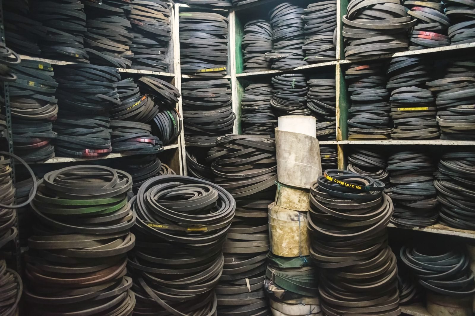 Floor-to-ceiling shelves packed with coiled rubber drive belts