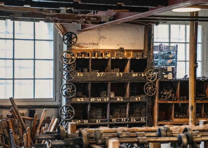 Old wooden pigeonhole bins with chalk numbers in a workshop