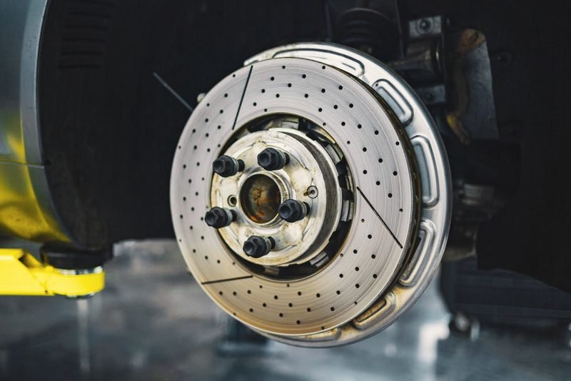 Brake rotor and wheel hub on a car raised in a shop